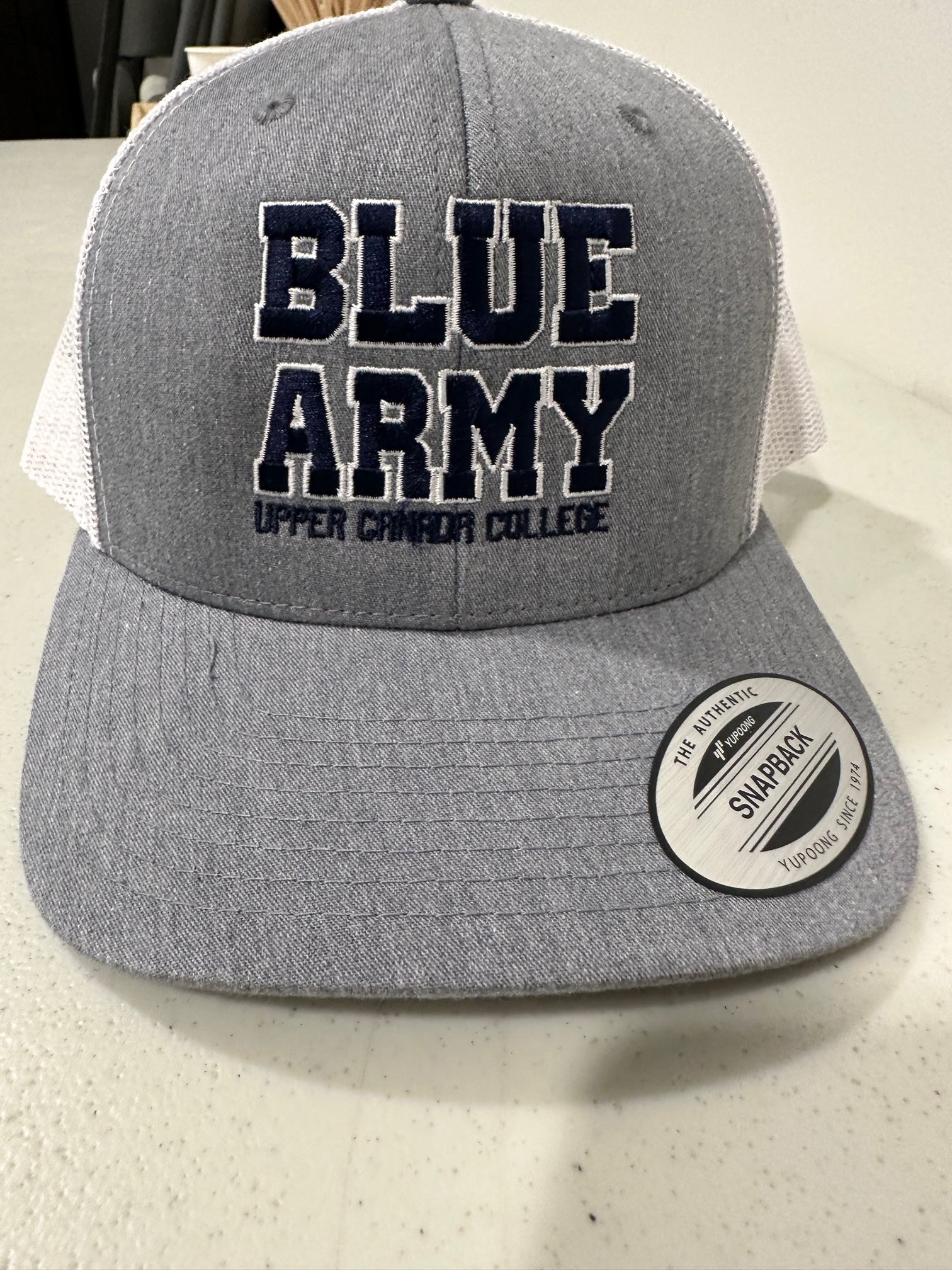 Grey trucker hat blue lettering - Blue Army